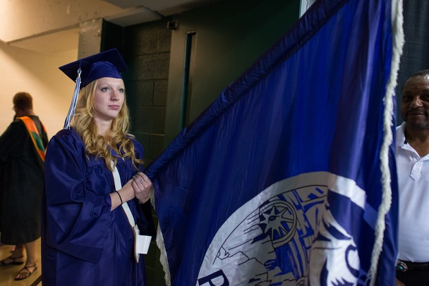 Graduate Abigail Raver holds Pioneer's flag before the processional during Pioneer's class of 2013 graduation ceremony at EMU's Convocation Center Thursday, June 6.Courtney Sacco I AnnArbor.com 